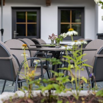 Apartment near Zell am Ziller? Your farmhouse holiday home. Outdoor café area with tables, chairs, and small flower vases