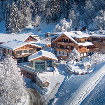 Your accommodation in Zillertal for holidays with friends Snow-covered houses and trees in a winter mountain village